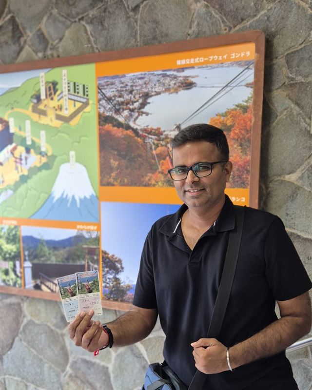 Varun holding ropeway tickets near Mt. Fuji